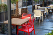 Red and white chairs in the restaurant after rain diagonally in the frame