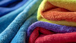 Vibrant terrycloth towels in a cozy, colorful stack.