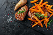 sweet potato fries with grilled steak on stone plate, top view