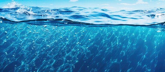 Canvas Print - A closeup shot of a wave in the ocean, showcasing the vibrant hues of blue and azure in the water. The fluid motion captures the essence of coastal and oceanic landforms