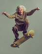 An elderly man jumping with the skateboard, happy and smiling. youthful energy, subject isolated on background