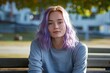Portrait of a beautiful young woman with purple hair in the park