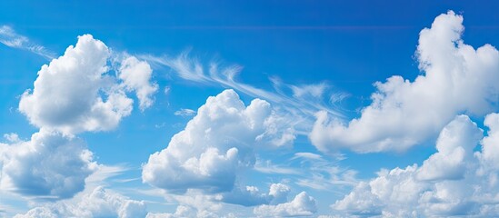 Wall Mural - Numerous clouds float in the sky above a tranquil body of water