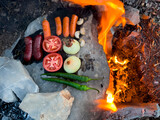 Fototapeta Natura - delicious food over wood fire and on stone