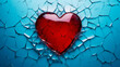 A shattered red heart against a stark blue background symbolizing heartbreak, broken relationship and emotional pain. Concept of lost love or betrayal.