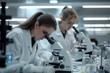 Scientists using microscopes in a lab 