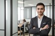 © PNG&Background Image - Handsome businessman standing with arms crossed, smiling and looking at the camera, standing against blurred bright office background with copy space.