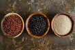 Red, black and white quinoa seeds on rustic table background,top view