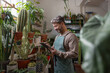 © ReeldealHD images - Plant shop owner using a digital tablet in store for customer orders