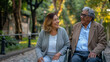 © Studio Nova - A smiling couple enjoys a moment together in a park, with one seated in a wheelchair.