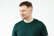 © Alexey - A man in a green T-shirt shows emotions in front of the camera