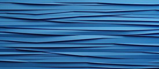 Poster - The image features a wall painted in blue, adorned with intricate paper waves design.