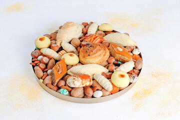Sticker - Traditional Azerbaijan holiday Novruz background with green semeni,traditional azerbaijan sweets,shekerbura,qogal,paxlava,mutaki and different nuts and sweets,top view,space for copy
