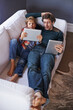 © Marius Venter/peopleimages.com - Father, son and tablet for gaming on sofa together, technology and online streaming for bonding at home. Digital world, internet and man with boy child in living room, gamer app and entertainment