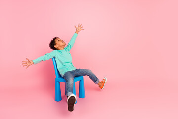 Canvas Print - Full size photo of charming small boy sit chair excited play look empty space dressed stylish cyan outfit isolated on pink color background