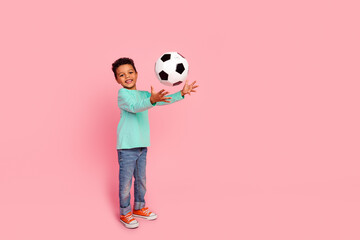 Sticker - Full length photo of adorable little boy catch soccer ball dressed stylish cyan garment isolated on pink color background