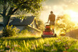 a man mows the lawn with a lawnmower on his plot next to his house