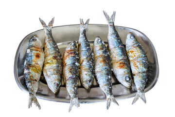 Traditional Portuguese grilled sardines with coarse salt on a metal plate isolated on a white background.