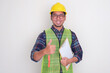 © KrishnaTedjo - A construction worker smiling and give thumb up while holding checklist on clipboard