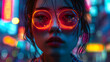 Intriguing close-up of a young woman wearing glasses with neon reflections illuminating her eyes and face