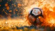 Weathered soccer ball caught in a vibrant explosion of orange sparks