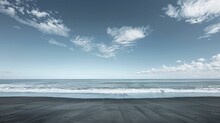 The Endless Horizon Of The Pacific Ocean Viewed From A Deserted Beach, Where The Sky And Water Meet In A Vast Expanse.