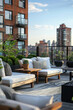 Chic rooftop patio lounge with comfortable furnishings set against an urban skyline at sunset