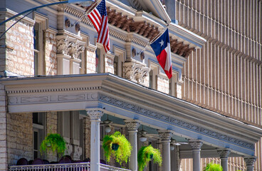 Canvas Print - American and Texas state flags flying in front of Austin building