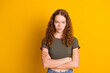 Photo of serious angry unsatisfied woman standing with crossed hands problem trouble conflict fight isolated on yellow color background