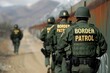 © blvdone - Border patrol officers walking along border