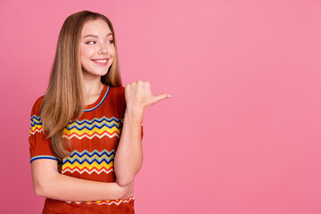 Sticker - Portrait of nice cheerful girl look indicate thumb finger empty space offer isolated on pink color background