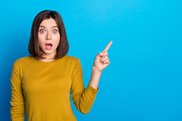 Canvas Print - Photo of cute shocked woman wear shirt open mouth showing finger empty space isolated blue color background