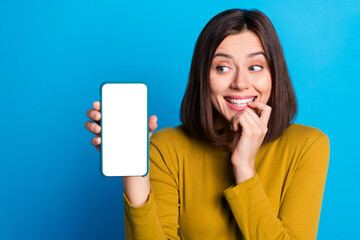 Photo of cunning funky woman wear shirt showing looking modern gadget empty space isolated blue color background