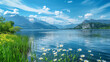 Scenic view of tranquil lake and snow-capped mountains with wildflowers
