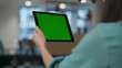 © stockbusters - Green screen tablet user videocalling at lounge closeup. Woman talking computer