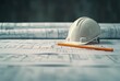 A white hard hat sits on top of a pencil on a sheet of paper. Concept of construction or engineering work, with the hard hat and pencil being essential tools for the job