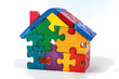 House made of colorful puzzle, white background