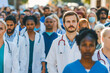 © MVProductions - A group of people in medical uniform, a rally of doctors with the unity and determination of healthcare professionals. Concept: medical workers, strike or social issues in health and clinics