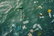 Plastic bottles and trash floating on ocean