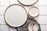 Fototapeta Tulipany - Flat lay textured ripple empty grey ceramic plate with napkin on grey background