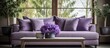 An up-close view of a lavender couch adorned with pillows and a wooden coffee table