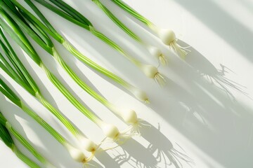 Wall Mural - Fresh Green Onions Arranged in Zigzag Pattern on White