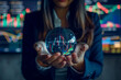 Stock market prediction, financial forecasting. Woman holding a crystal globe with a candlestick chart showing in it. High quality photo