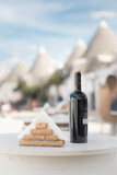 Fototapeta Tęcza - A bottle of wine on the table. Alberobello. ITALY