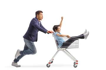 Wall Mural - Young man pushing his kid inside a shopping cart