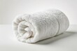 White rolled up towel isolated on white background