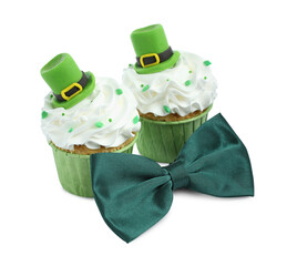 Wall Mural - St. Patrick's day party. Tasty festively decorated cupcakes and green bow tie, isolated on white