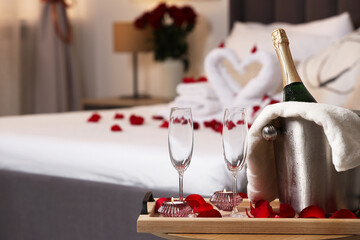 Wall Mural - Honeymoon. Sparkling wine and glasses on wooden table in room. Space for text