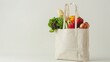 Shopping bag with groceries inside on white background, copy space for text