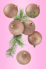 Wall Mural - Beautiful Christmas balls and fir tree branches falling on pink background